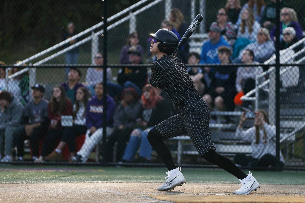 Lynnwood’s Gavin Harrington sends a fly ball to the outfield during a game against Lake Stevens on Friday, March 17, 2023, at Lake Stevens High School in Lake Stevens, Washington. (Ryan Berry / The Herald)