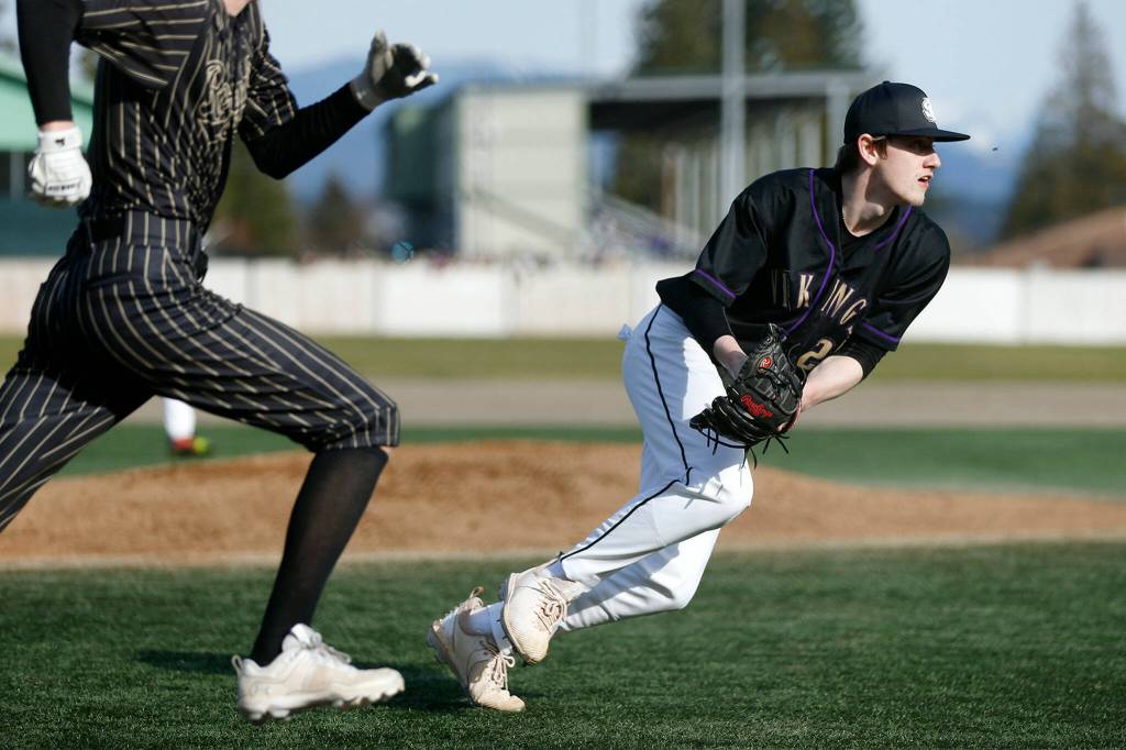Lake Stevens pitcher Kaiden Sekely fields a bunt and throws out the runner during a game against Lynnwood on Friday, March 17, 2023, at Lake Stevens High School in Lake Stevens, Washington. (Ryan Berry / The Herald)