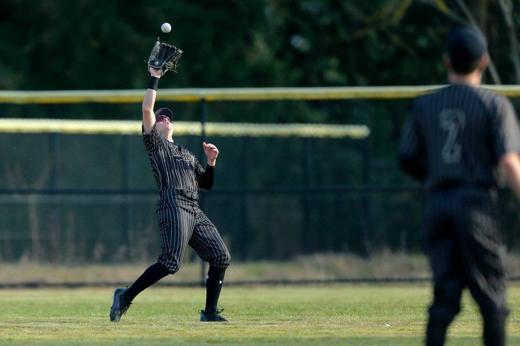 Lynnwood’s Keenan Masters snags a fly ball in center field during a game against Lake Stevens on Friday, March 17, 2023, at Lake Stevens High School in Lake Stevens, Washington. (Ryan Berry / The Herald)