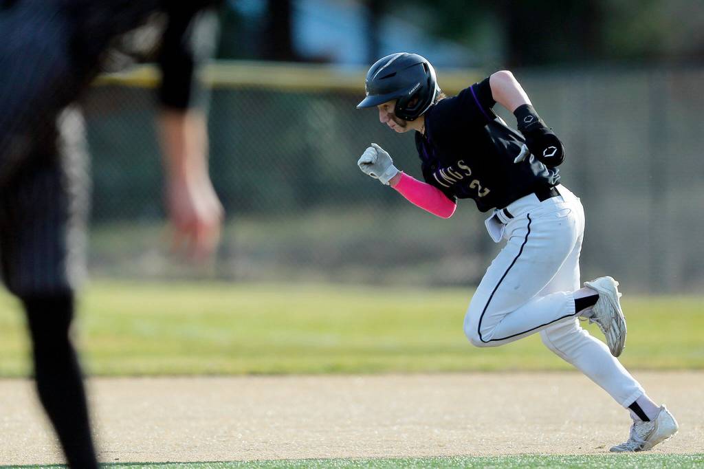 Lake Stevens’ Aspen Alexander takes off on the pitch during a game against Lynnwood on Friday, March 17, 2023, at Lake Stevens High School in Lake Stevens, Washington. (Ryan Berry / The Herald)