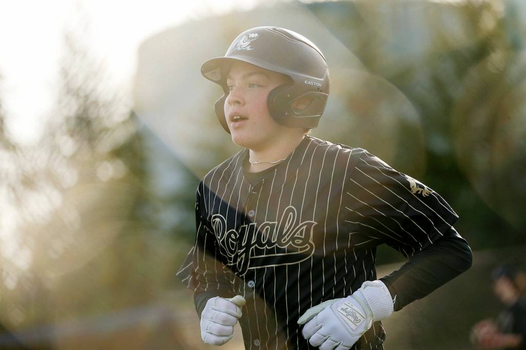 Lynnwood freshman Douglas McGuire heads back to a cheering dugout after scoring his team’s first run of the day during a game against Lake Stevens on Friday, March 17, 2023, at Lake Stevens High School in Lake Stevens, Washington. (Ryan Berry / The Herald)