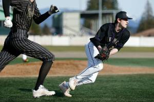 Lake Stevens pitcher Kaiden Sekely fields a bunt and throws out the runner during a game against Lynnwood on Friday, March 17, 2023, at Lake Stevens High School in Lake Stevens, Washington. (Ryan Berry / The Herald)