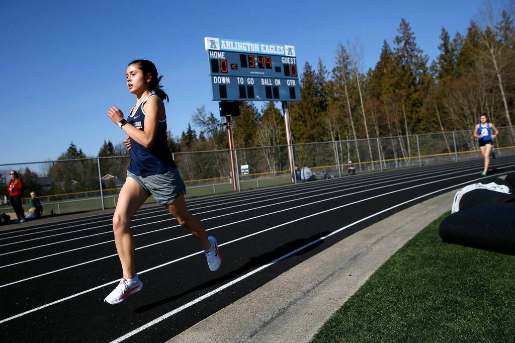 A Glacier Peak runner makes the final turn in the 800 meter run during the Chuck Randall Invite at Arlington High School on Saturday, March 18, 2023, in Arlington, Washington. (Ryan Berry / The Herald)