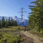 Hikers walk along a section of the Heybrook Ridge Trail that runs underneath power lines on Friday, March 18, 2023, in Index, Washington. (Kayla Dunn / The Herald).