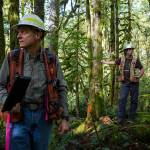 Department of Natural Resources regional manager Allen McGuire, left, and acting bolder unit forester Tyson Whiteid, right, stand next to marker on land recently purchased by the DNR for timber harvest on Wednesday, Sept. 25, 2019 in Gold Bar, Wash. (Olivia Vanni / The Herald)