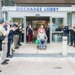 Everett police officers and civilian employees greet officer Chad House on Thursday, March 23, 2023, as hes wheeled out of Providence Regional Medical Center Everett. (Everett Police Department)