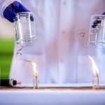 A standard jet fuel, left, burns with extensive smoke output while a sustainable avation fuel, right, produces less smoke during a demonstration of the difference in fuel emissions on Tuesday, March 28, 2023 in Everett, Washington. (Olivia Vanni / The Herald)