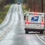 A mail carrier delivers mail along Dubuque Road in Snohomish on Wednesday, Jan. 12, 2022. (Olivia Vanni / The Herald)