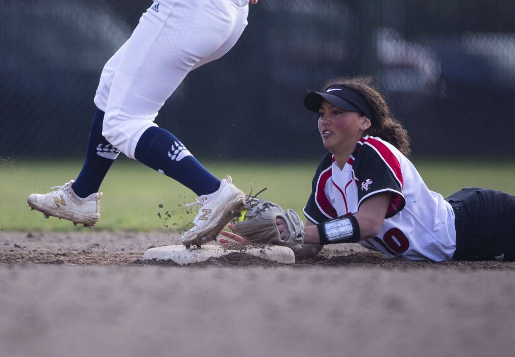 Snohomishs Emma Hansen dives to try and beat the runner to second base during a game against Glacier Peak on March 16, 2022, in Snohomish. (Olivia Vanni / The Herald)