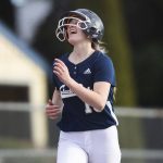 Glacier Peaks Faith Jordan laughs at her teammates as she runs toward home plate after hitting a home run during a game against Snohomish on March 16, 2022, in Snohomish. (Olivia Vanni / The Herald)