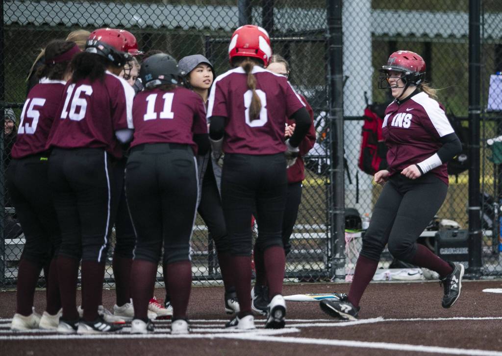 Cascades Alexa Hamshaw is congratulated by her teammates after hitting a home run during a game against Lakewood on March 13, 2023, in Everett. (Olivia Vanni / The Herald)
