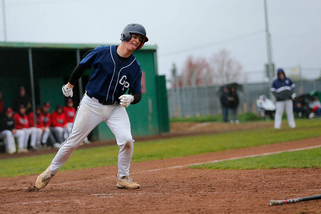Glacier Peaks Logan Hall sticks his tongue out after drawing a four-pitch walk against Snohomish on Friday, March 31, 2023, at Earl Torgeson Field in Snohomish, Washington. (Ryan Berry / The Herald)