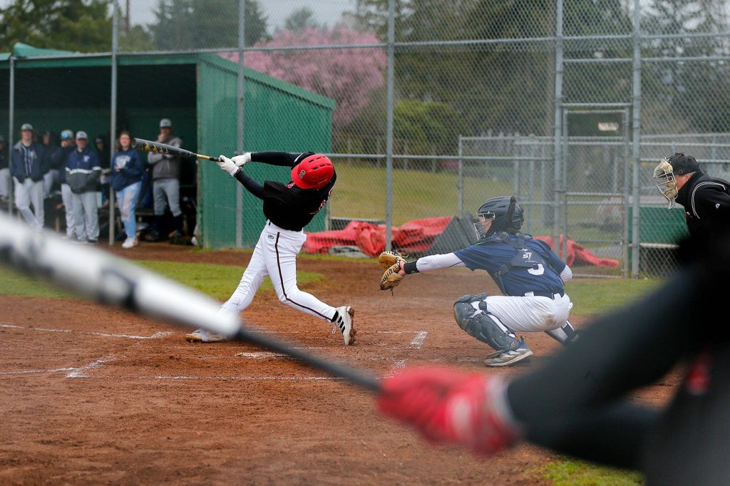 A Snohomish player puts the ball in play against Glacier Peak on Friday, March 31, 2023, at Earl Torgeson Field in Snohomish, Washington. (Ryan Berry / The Herald)