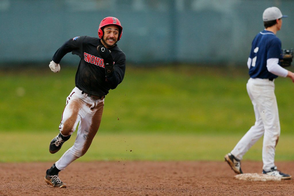 Snohomishs Nickolas Sakamoto advances two bases on an errant throw by Glacier Peak on Friday, March 31, 2023, at Earl Torgeson Field in Snohomish, Washington. (Ryan Berry / The Herald)