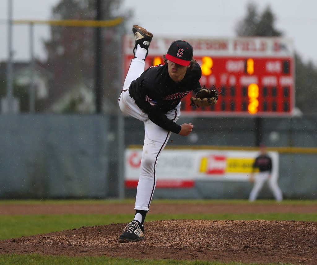 Snohomish’s Jackson Weeks almost loses his hat while pitching against Glacier Peak on Friday, March 31, 2023, at Earl Torgeson Field in Snohomish, Washington. (Ryan Berry / The Herald)