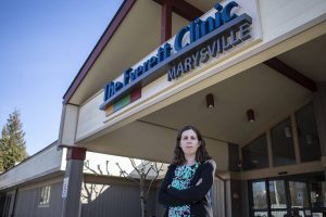 Kate Spencer poses for a photo outside The Everett Clinic in Marysville, Washington on Tuesday, March 21, 2023. Kate is a Deaf patient who has struggled with access challenges at The Everett Clinic. (Annie Barker / The Herald)