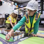 Matthew Sims places a traffic signal for his groups traffic project presentation at Hazelwood Elementary School on Wednesday, March 29, 2023 in Lynnwood, Washington. (Olivia Vanni / The Herald)