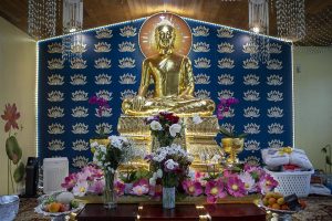 Flowers and other items are displayed in memory and honor of Khalea Thoeuk and Riley Danard inside a Buddhist Temple at 16626 9th Avenue SE in Mill Creek, Washington on Thursday, March 30, 2023.  (Annie Barker / The Herald)