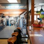 A photo mural of Three Bull Brewings brewhouse covers an entire wall at the new taproom on Wednesday, April 19, 2023, in Snohomish, Washington. (Ryan Berry / The Herald)