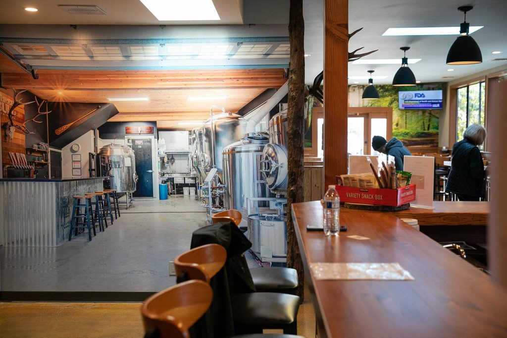 A photo mural of Three Bull Brewings brewhouse covers an entire wall at the new taproom on Wednesday, April 19, 2023, in Snohomish, Washington. (Ryan Berry / The Herald)