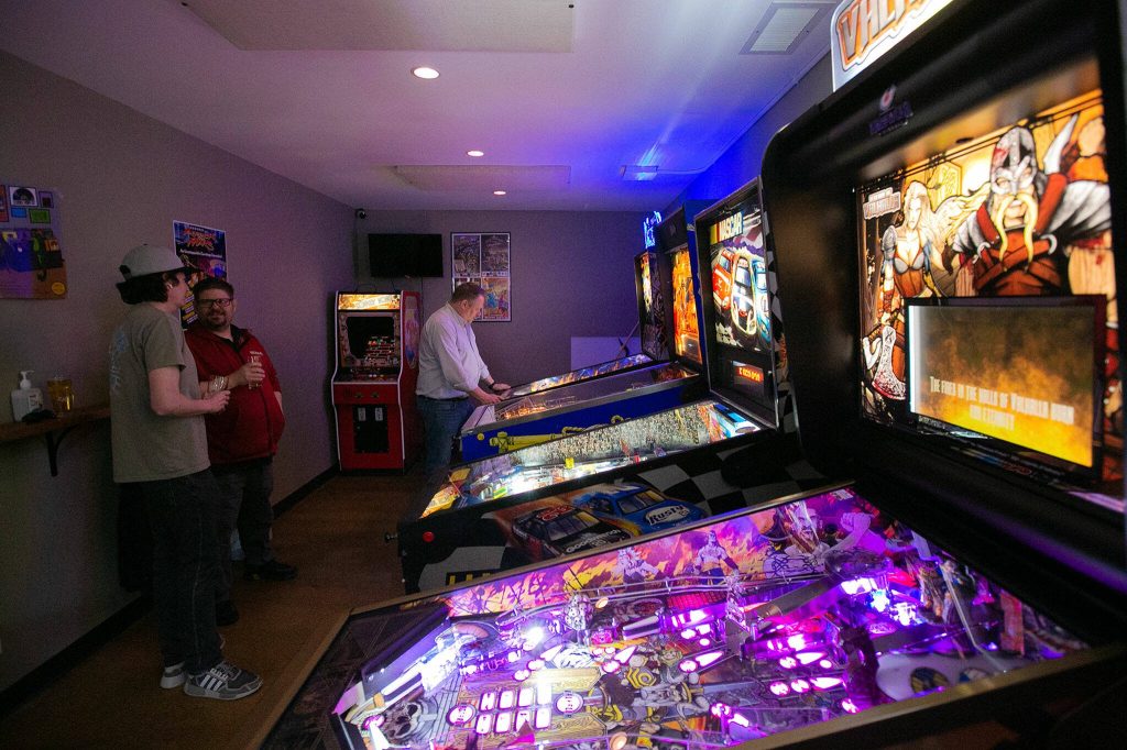 Pinball and other arcade games are set up in a back room at Three Bull Brewing on Wednesday, April 19, 2023, in Snohomish, Washington. (Ryan Berry / The Herald)