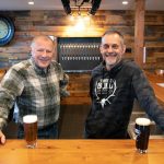 "Big Bull" Gary Pritzkau and his son Cary Pritzkau, who are two of multiple people involved in the operation of Three Bull Brewing, stand behind the bar at their new tap house on Wednesday, April 19, 2023, in downtown Snohomish, Washington. (Ryan Berry / The Herald)