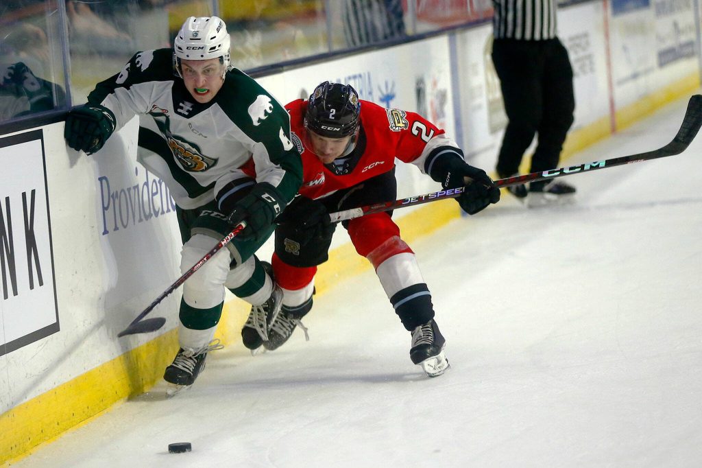 Everett Silvertips Ty Gibson narrowly avoids a hard hit during Game 3 of a first-round WHL playoff series on Monday at Angel of the Winds Arena in Everett. (Ryan Berry / The Herald)