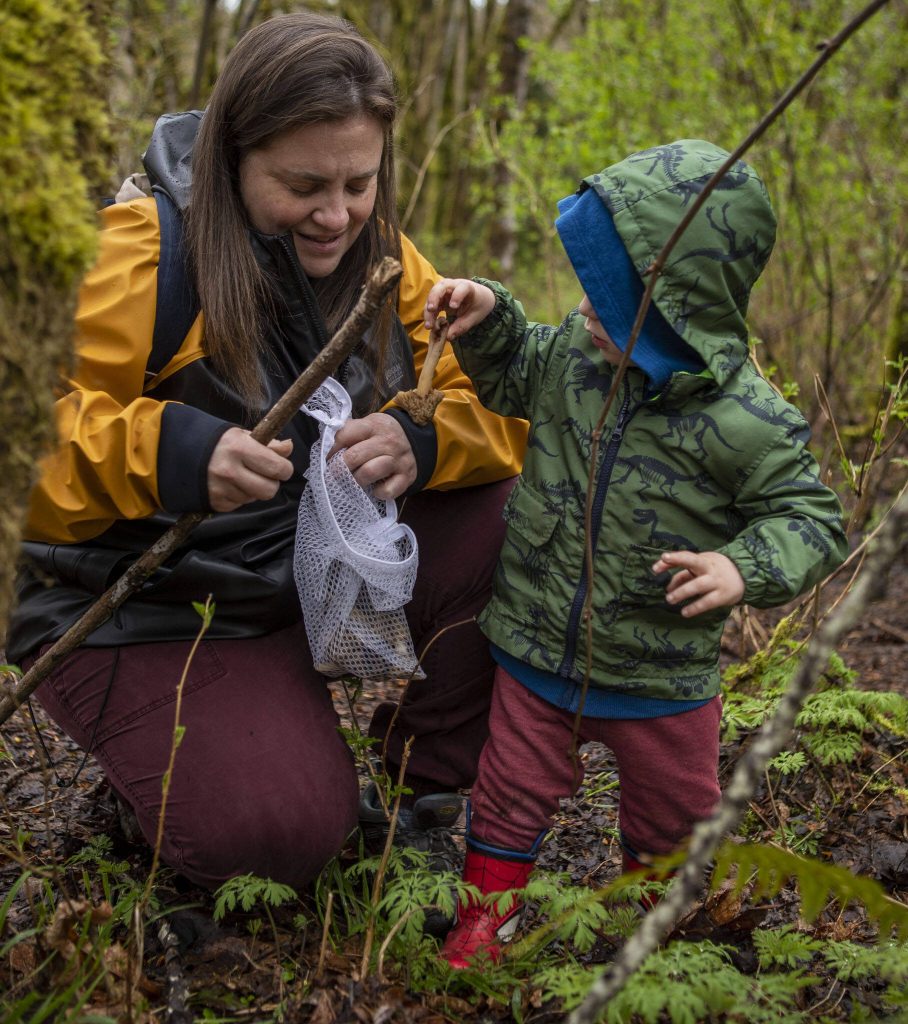 Elizabeth Swett, left, and Mark Swett, right, collect mushrooms with the Snohomish County Mycological Society at Lord Hill Park on Saturday, April 8, 2023 in Snohomish, Washington. (Annie Barker / The Herald)