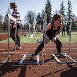 Hurdlers run exercises during a track and field practice after school at Lake Stevens High School in Lake Stevens, Washington on Wednesday, March 22, 2023. The team has over 300 members. (Annie Barker / The Herald)