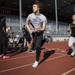 Relay racers practice next to sprinters during a track and field practice after school at Lake Stevens High School in Lake Stevens, Washington on Wednesday, March 22, 2023. The team has over 300 members. (Annie Barker / The Herald)