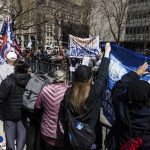 Anti-Trump supporters face off against Trump supporters from a separate pen at a protest held in Collect Pond Park across the street from the Manhattan District Attorneys office in New York on Tuesday, April 4, 2023. Former President Donald Trump, who faces multiple election-related investigations, will surrender and be arraigned at Manhattan court Tuesday on criminal charges stemming from 2016 hush money payments. (AP Photo/Stefan Jeremiah)