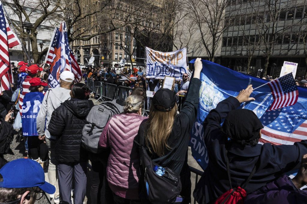 Anti-Trump supporters face off against Trump supporters from a separate pen at a protest held in Collect Pond Park across the street from the Manhattan District Attorneys office in New York on Tuesday, April 4, 2023. Former President Donald Trump, who faces multiple election-related investigations, will surrender and be arraigned at Manhattan court Tuesday on criminal charges stemming from 2016 hush money payments. (AP Photo/Stefan Jeremiah)