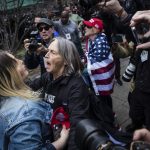 Protesters argue at the Collect Pond Park across the street from the Manhattan District Attorneys office in New York on Tuesday, April 4, 2023. Former President Donald Trump will surrender in Manhattan on Tuesday to face criminal charges stemming from 2016 hush money payments. (AP Photo/Stefan Jeremiah)