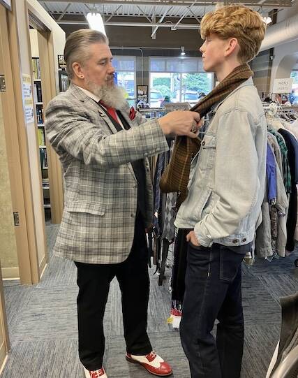 Spiffy Thrifty Fashion coach Tim Lambright, left, adjusts a scarf on Von Sandeno, 15, during a thrifting session on April 1, 2023. (Submitted photo)