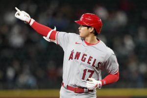 Los Angeles Angels designated hitter Shohei Ohtani points to the outfield as he runs the bases after hitting a two-run home run against the Seattle Mariners in the fifth inning during a baseball game Monday, April 3, 2023, in Seattle. (AP Photo/Lindsey Wasson)