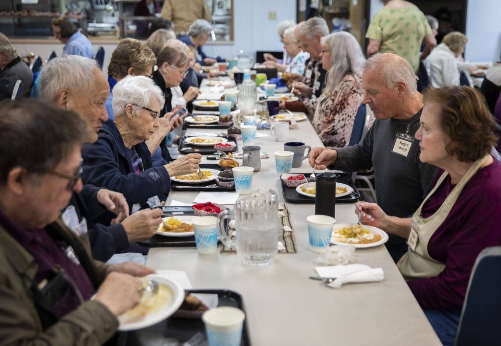 People enjoy lunch at the Lake Stevens Senior Center on Wednesday, April 12, 2023 in Everett, Washington. (Olivia Vanni / The Herald)