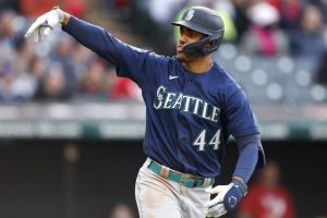 Seattle Mariners' Julio Rodriguez celebrates as he rounds the bases after hitting a two-run home run off Cleveland Guardians relief pitcher Nick Sandlin during the sixth inning of a baseball game, Friday, April 7, 2023, in Cleveland. (AP Photo/Ron Schwane)