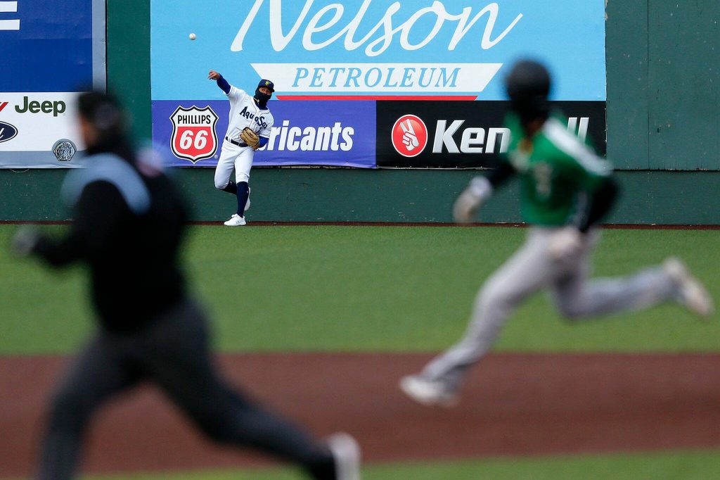 AquaSox center fielder Jonatan Clase gets the ball back to the infield on a first inning triple during the season opener against the Eugene Emeralds on Friday, April 7, 2023, at Funko Field in Everett, Washington. (Ryan Berry / The Herald)
