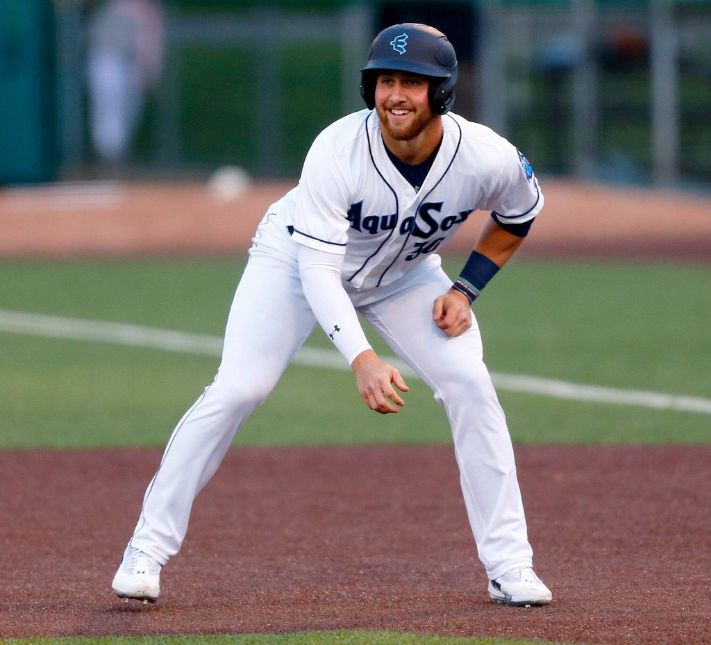 AquaSox first baseman Tyler Locklear smiles while taking a leadoff after getting on base in his first at bat during the season opener against the Eugene Emeralds on Friday, April 7, 2023, at Funko Field in Everett, Washington. (Ryan Berry / The Herald)