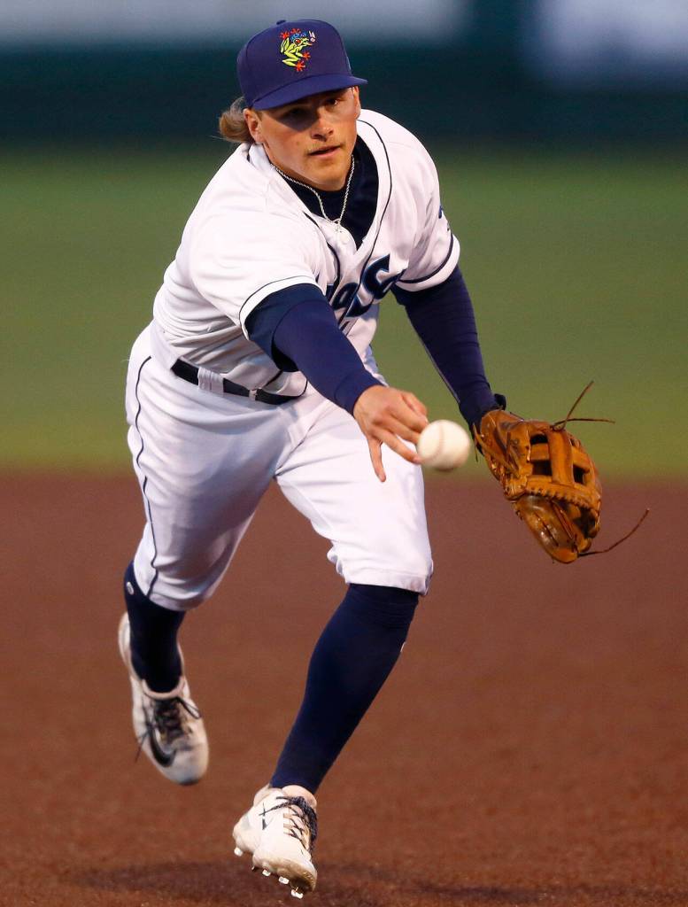 AquaSox second baseman Blake Rambusch shovels a ball over to first on a slow dribbler during the season opener against the Eugene Emeralds on Friday, April 7, 2023, at Funko Field in Everett, Washington. (Ryan Berry / The Herald)