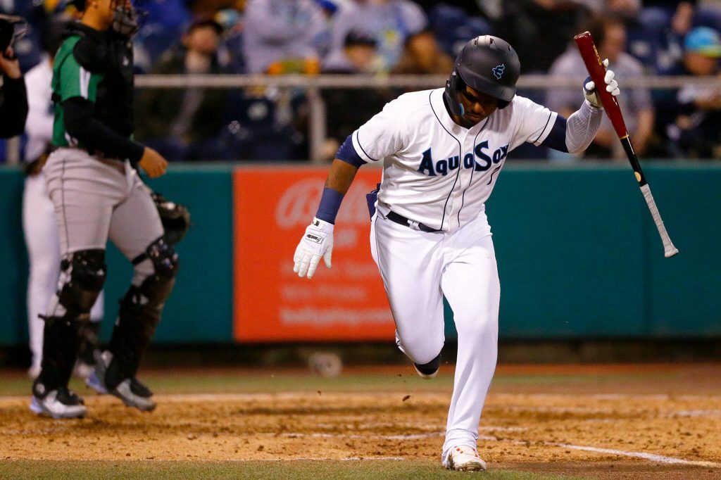 AquaSox outfielder Alberto Rodriguez throws his bat in frustration after popping up with a runner on base during the season opener against the Eugene Emeralds on Friday, April 7, 2023, at Funko Field in Everett, Washington. (Ryan Berry / The Herald)