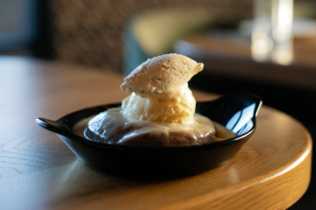 Butter Cake, covered in all types of dairy goodness, is one of a few desserts to end a meal with at Rare Society on Tuesday, April 25, 2023, in Mill Creek, Washington. (Ryan Berry / The Herald)