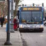 A transit rider steps onto a Community Transit bus on Tuesday, Jan. 3, 2023 in Everett, Washington. (Olivia Vanni / The Herald)
