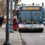 A transit rider steps onto a Community Transit bus on Tuesday, Jan. 3, 2023 in Everett, Washington. (Olivia Vanni / The Herald)