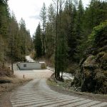 The Woods Creek Hydroelectric Project powerhouse is nestled at the bottom of a hill on Thursday, April 13, 2023, in Monroe, Washington. (Ryan Berry / The Herald)
