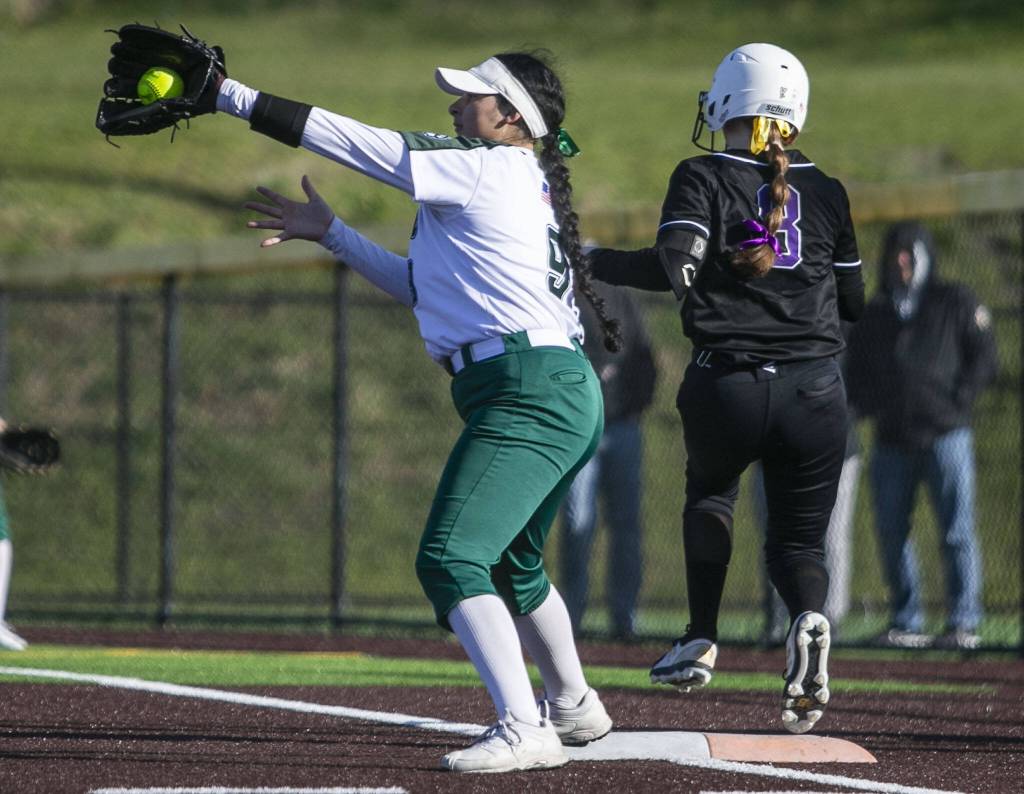 Simone Williams catches the ball to get an out at first during the game against Kamiak on Tuesday, April 11, 2023 in Everett, Washington. (Olivia Vanni / The Herald)