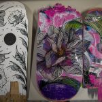 Skateboards by artists Rio Allen, left, and Dana Teruya Len, right, at Graphite Arts Center in Edmonds, Washington on Saturday, April 15, 2023. A silent auction of skateboard art will be held to raise money to kick-start Riveras new nonprofit, Salvage Arts. (Annie Barker / The Herald)