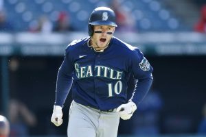 Seattle Mariners' Jarred Kelenic celebrates as he runs out a one-run double off Cleveland Guardians relief pitcher Enyel De Los Santos during the 11th inning of a baseball game, Sunday, April 9, 2023, in Cleveland. (AP Photo/Ron Schwane)