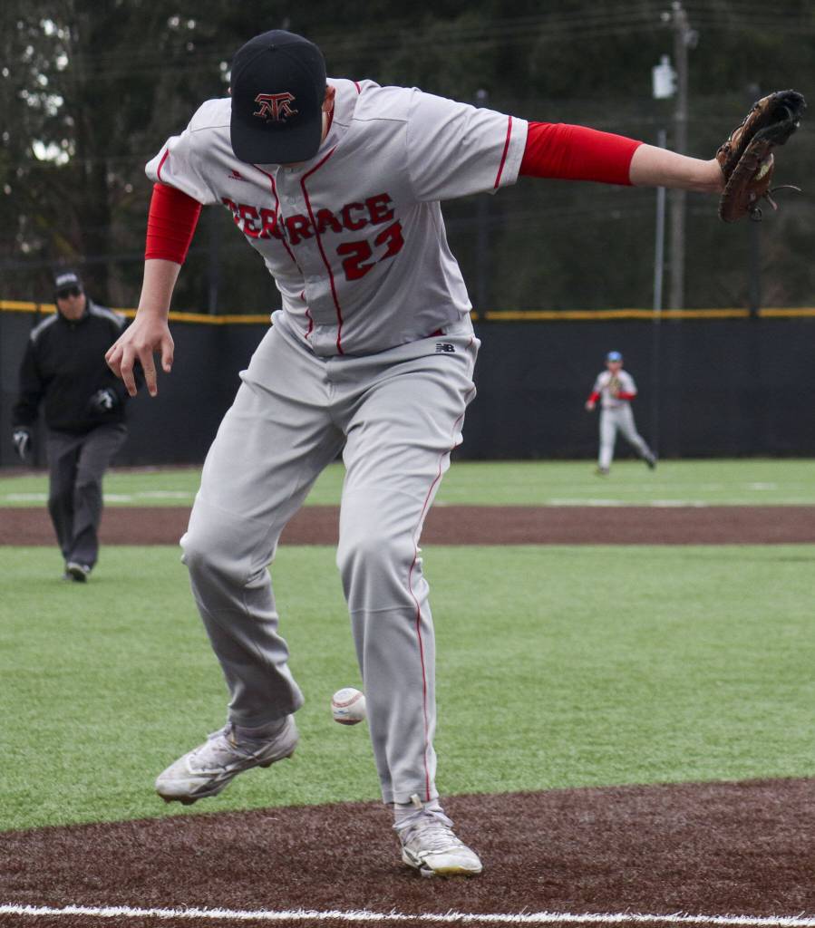 Mountlake Terraces Ethan Swenson (23) drops the ball during a baseball game between Edmonds-Woodway and Mountlake Terrace at Edmonds-Woodway High School in Edmonds, Washington on Thursday, April 13, 2023. The Warriors won, 5-1. (Annie Barker / The Herald)