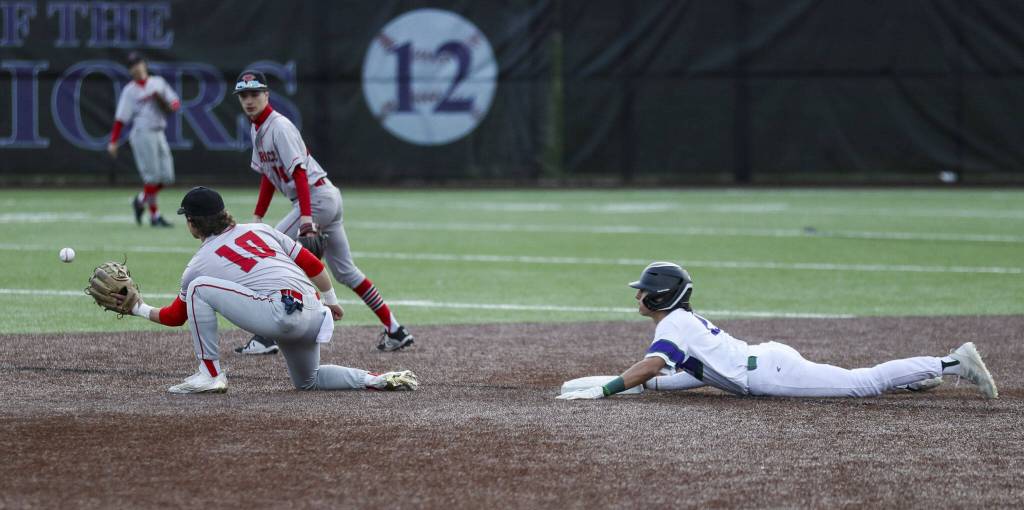 Edmonds-Woodways Diego Escandon (2) slides into second during a baseball game between Edmonds-Woodway and Mountlake Terrace at Edmonds-Woodway High School in Edmonds, Washington on Thursday, April 13, 2023. The Warriors won, 5-1. (Annie Barker / The Herald)